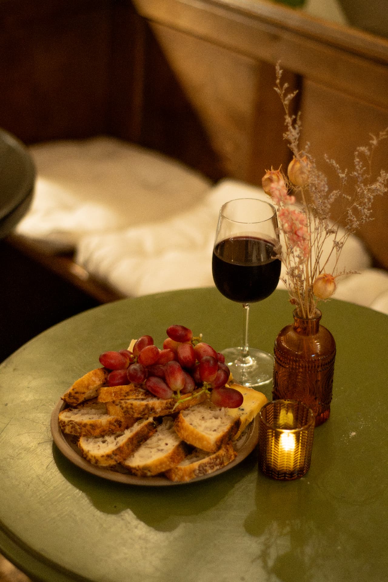 Candlelit table at Viv's Coffee with wine and dried flowers